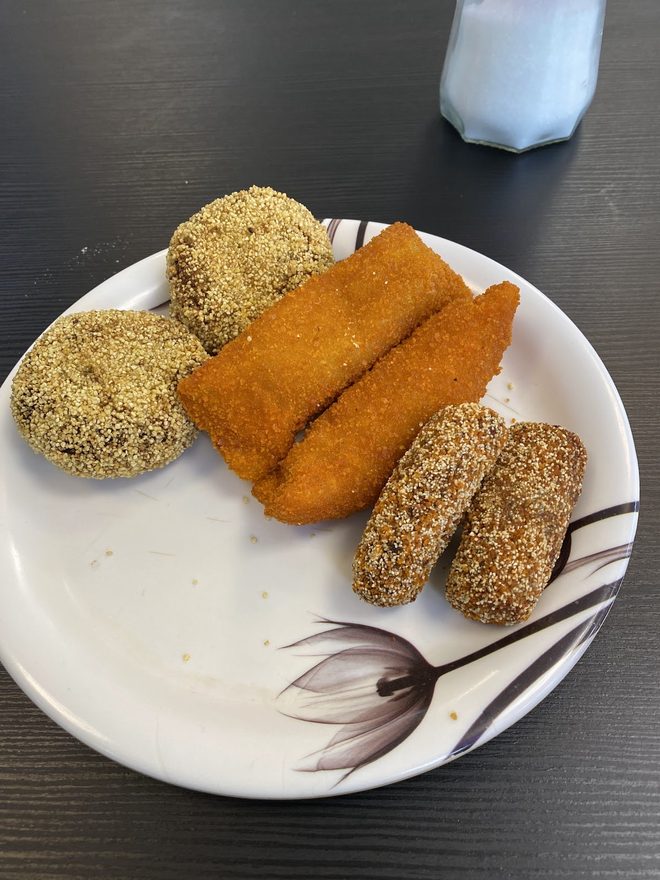 Cutlets, rissole and croquettes on a floral plate