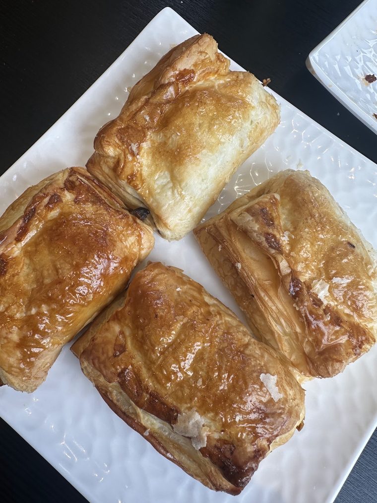 Golden puff pastries stacked on a plate